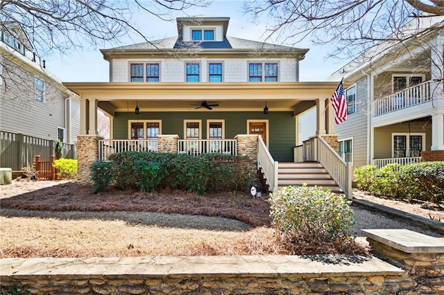 american foursquare style home with a porch and a ceiling fan