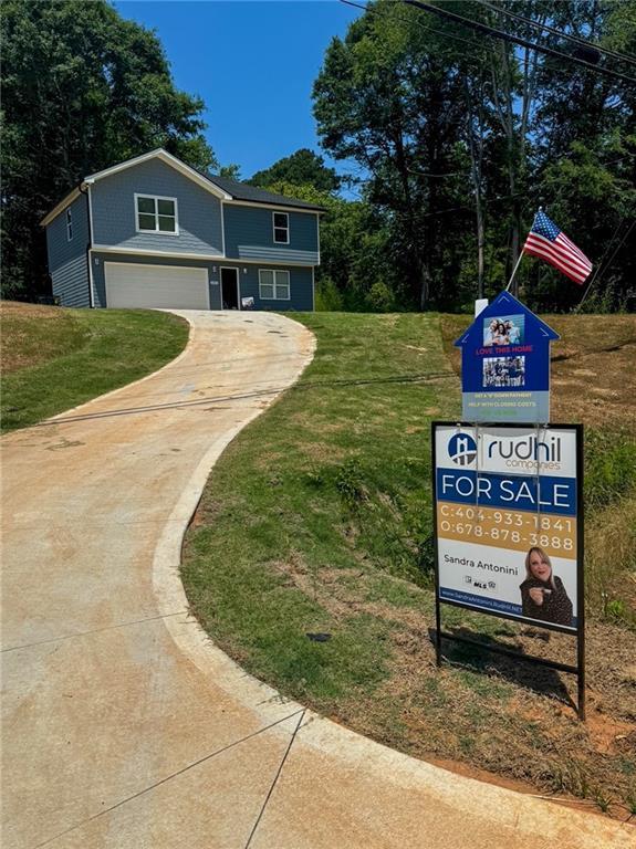exterior space with a garage, driveway, and a front yard