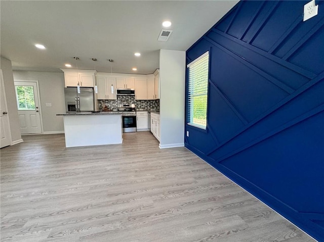 1351 E Atlanta Rd E, Stockbridge, GA 30281 - kitchen with stainless steel appliances, light wood-style flooring, white cabinetry, backsplash, and recessed lighting