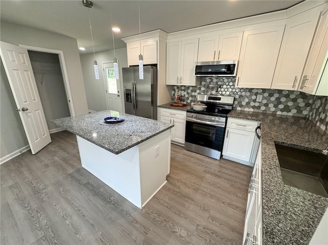 1351 E Atlanta Rd E, Stockbridge, GA 30281 - kitchen featuring appliances with stainless steel finishes, a kitchen island, light wood-style flooring, white cabinets, and recessed lighting