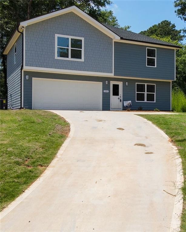 view of front of house with driveway, a front yard, cooling unit, and a garage