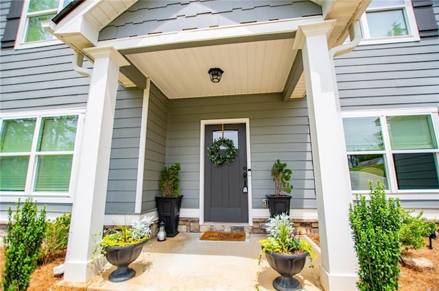 view of exterior entry with a porch
