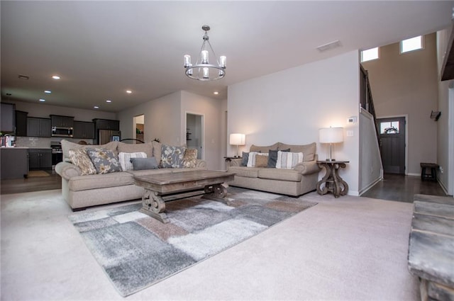 living area with an inviting chandelier, light carpet, recessed lighting, and a healthy amount of sunlight