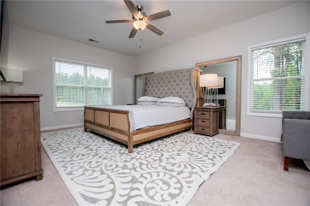 bedroom featuring visible vents, a ceiling fan, baseboards, and carpet floors