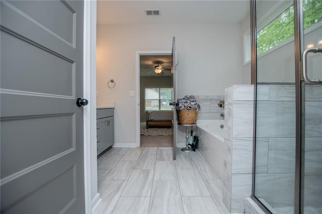 bathroom featuring ceiling fan, a bath, visible vents, vanity, and baseboards