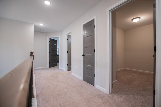 hallway featuring carpet floors, recessed lighting, and baseboards