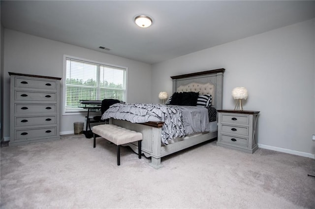 carpeted bedroom with baseboards and visible vents