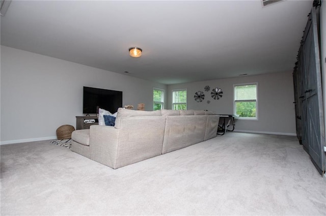 carpeted living area with baseboards