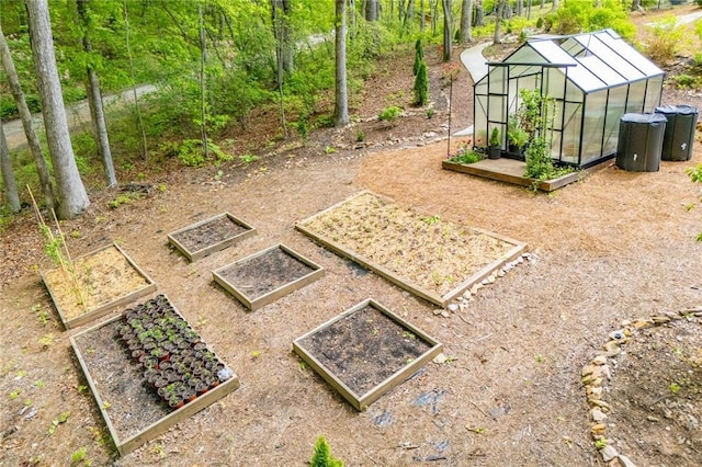 view of yard featuring an exterior structure, a garden, and an outbuilding