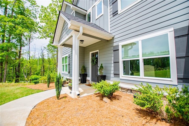 doorway to property featuring board and batten siding