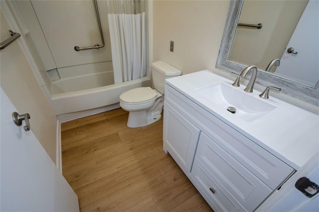 full bathroom with vanity, hardwood / wood-style flooring, toilet, and shower / bath combo with shower curtain