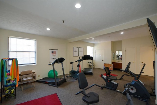 exercise room featuring carpet flooring and a textured ceiling