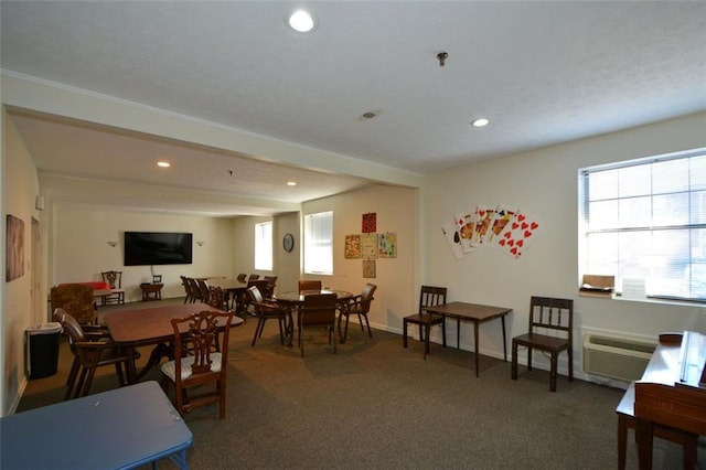 dining space with a wall mounted air conditioner and dark colored carpet