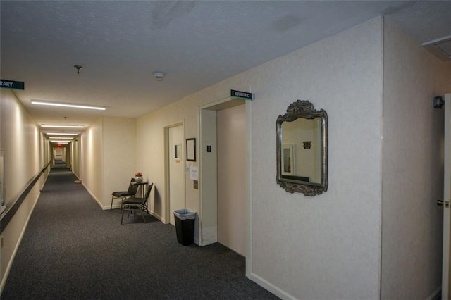 hall featuring dark carpet