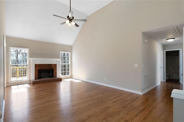 unfurnished living room with ceiling fan, a fireplace, wood finished floors, visible vents, and baseboards