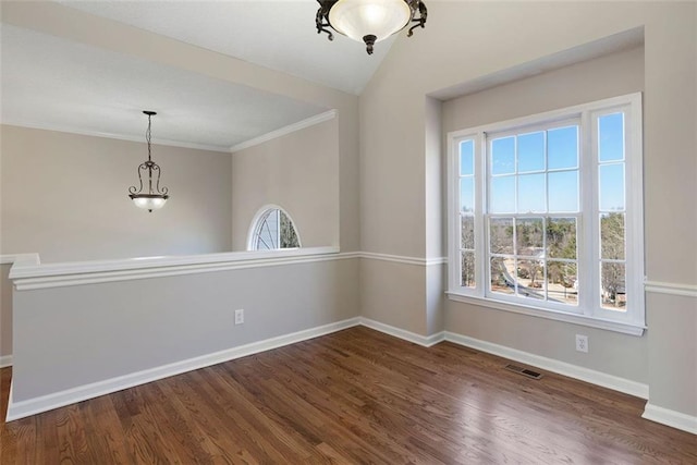 unfurnished dining area featuring plenty of natural light, wood finished floors, visible vents, and baseboards