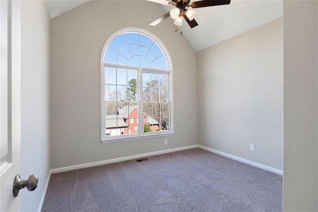 spare room with lofted ceiling, carpet, baseboards, and ceiling fan