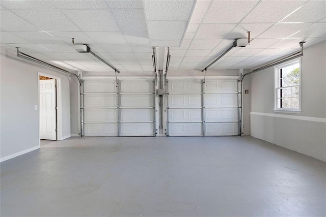 garage with baseboards and a garage door opener