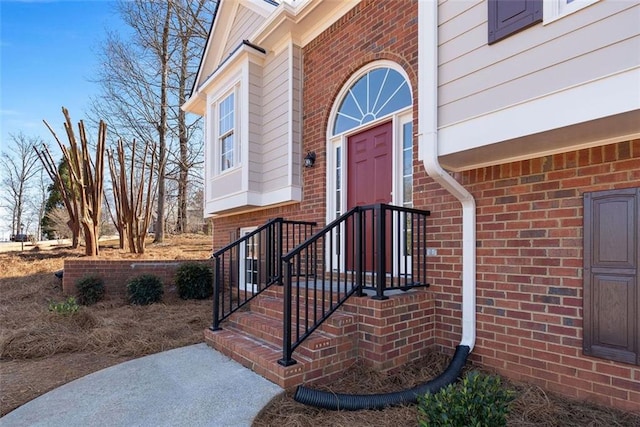 doorway to property with brick siding