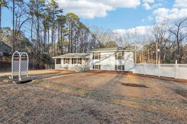 rear view of property with fence