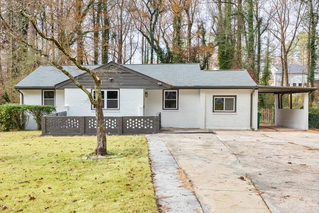 ranch-style house with a carport and a front yard