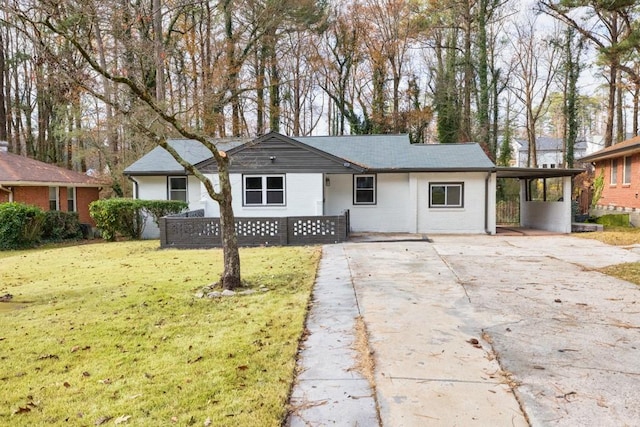 ranch-style house featuring a front yard and a carport