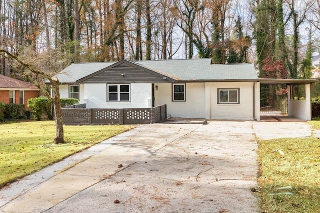 ranch-style house with a carport and a front lawn