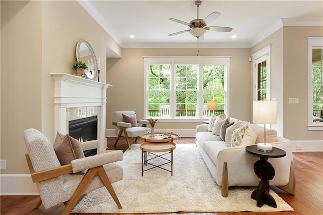 385 Windy Pines Trl, Roswell, GA 30075 - living area featuring healthy amount of natural light, a tile fireplace, ceiling fan, wood finished floors, and ornamental molding
