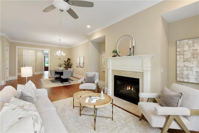 385 Windy Pines Trl, Roswell, GA 30075 - living area featuring wood finished floors, ceiling fan, a high end fireplace, a chandelier, and crown molding