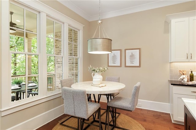 385 Windy Pines Trl, Roswell, GA 30075 - dining area with wood finished floors, baseboards, and crown molding