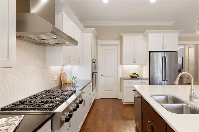 385 Windy Pines Trl, Roswell, GA 30075 - kitchen featuring wall chimney range hood, appliances with stainless steel finishes, a sink, crown molding, and backsplash