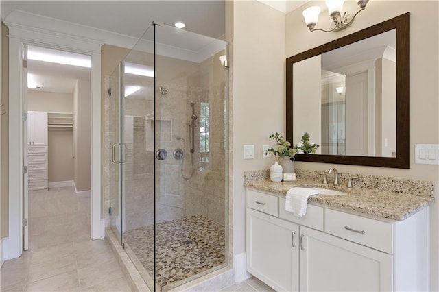 385 Windy Pines Trl, Roswell, GA 30075 - bathroom featuring a stall shower, vanity, baseboards, a spacious closet, and tile patterned floors