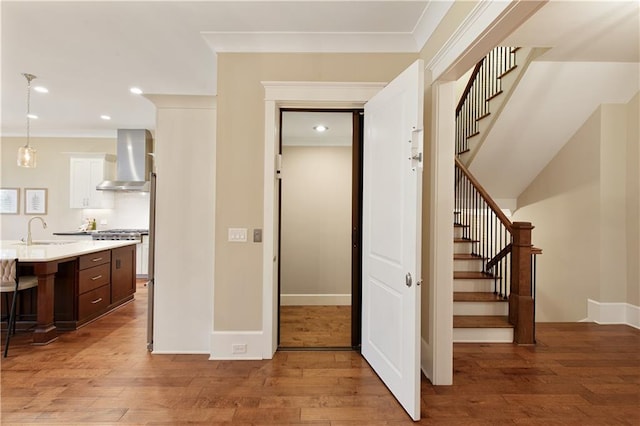 385 Windy Pines Trl, Roswell, GA 30075 - hallway with a sink, light wood-style flooring, recessed lighting, stairs, and ornamental molding