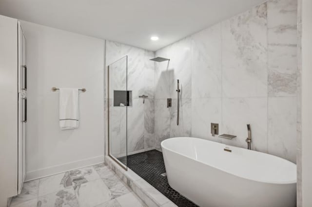 bathroom with tile walls and plus walk in shower