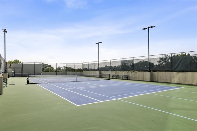 view of tennis court featuring basketball hoop