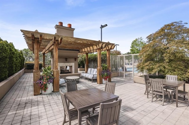 view of patio with a pergola and an outdoor living space with a fireplace