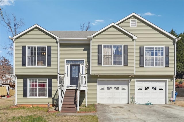 split foyer home with driveway and a garage