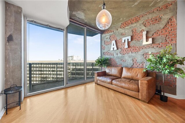 400 W Peachtree St NW Unit 3614, Atlanta, GA 30308 - sitting room featuring a wall of windows, wood finished floors, and baseboards