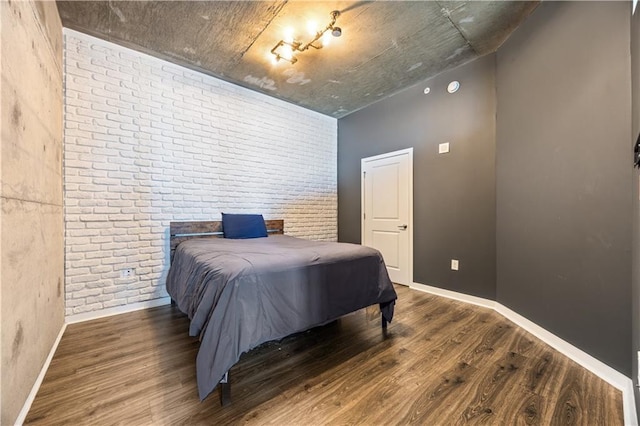 400 W Peachtree St NW Unit 3614, Atlanta, GA 30308 - bedroom featuring baseboards, wood finished floors, and brick wall