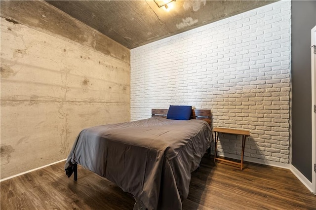 400 W Peachtree St NW Unit 3614, Atlanta, GA 30308 - bedroom with baseboards, wood finished floors, and brick wall
