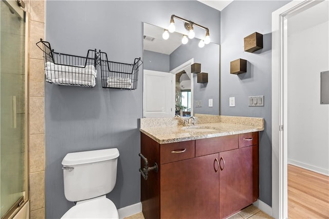 400 W Peachtree St NW Unit 3614, Atlanta, GA 30308 - bathroom featuring visible vents, baseboards, toilet, a shower with shower door, and vanity