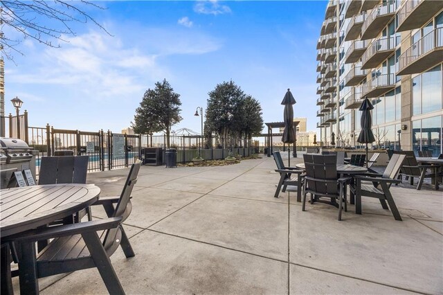 400 W Peachtree St NW Unit 3614, Atlanta, GA 30308 - view of patio / terrace featuring fence, a grill, and outdoor dining area