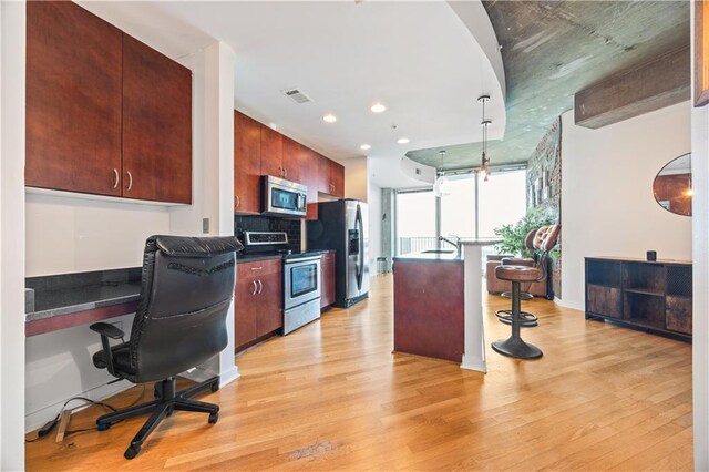 400 W Peachtree St NW Unit 3614, Atlanta, GA 30308 - kitchen with dark countertops, stainless steel appliances, light wood-type flooring, and recessed lighting