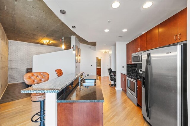 400 W Peachtree St NW Unit 3614, Atlanta, GA 30308 - kitchen with stainless steel appliances, a kitchen bar, light wood finished floors, and a sink