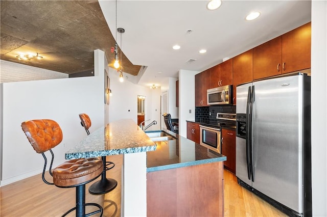 400 W Peachtree St NW Unit 3614, Atlanta, GA 30308 - kitchen featuring tasteful backsplash, recessed lighting, light wood-style flooring, appliances with stainless steel finishes, and a sink