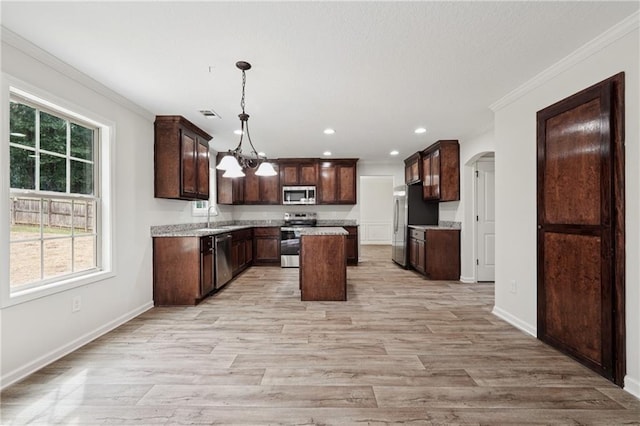 56 Sugar Leaf Ln, Jefferson, GA 30549 - kitchen with appliances with stainless steel finishes, arched walkways, ornamental molding, light wood-type flooring, and dark brown cabinetry