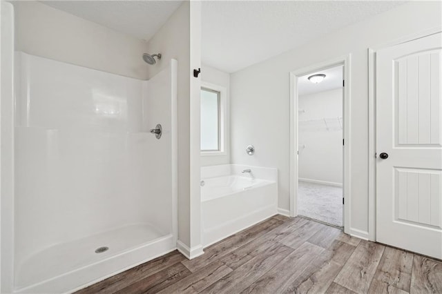 56 Sugar Leaf Ln, Jefferson, GA 30549 - bathroom with wood finished floors, a garden tub, and a shower