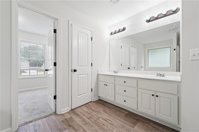 56 Sugar Leaf Ln, Jefferson, GA 30549 - full bath with double vanity, wood finished floors, and a textured ceiling