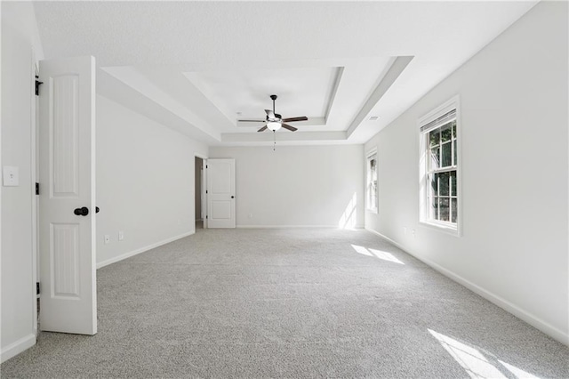 56 Sugar Leaf Ln, Jefferson, GA 30549 - spare room featuring a tray ceiling, a ceiling fan, and light carpet