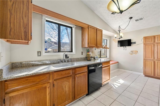 kitchen with light tile patterned flooring, a sink, black dishwasher, vaulted ceiling, and brown cabinets